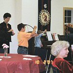 Linda Gibbs takes a lesson from the experts in the fine art of Yoyo. Left to Right: Jordan Johnson, Linda Gibbs, Morgan Johnson, Jacob Johnson. - Click to enlarge.